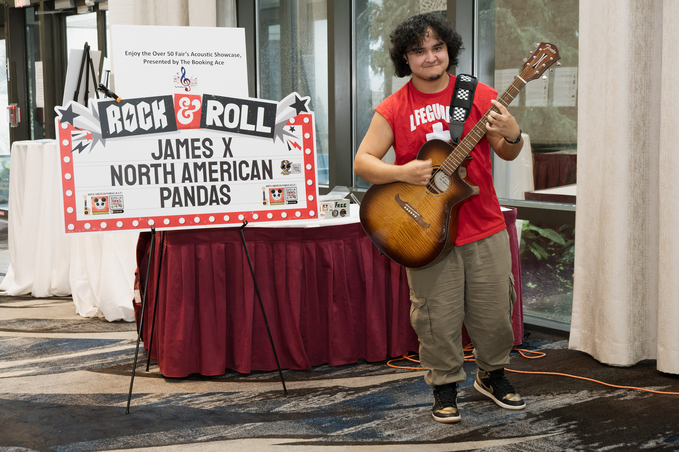A performer named James X plays the guitar