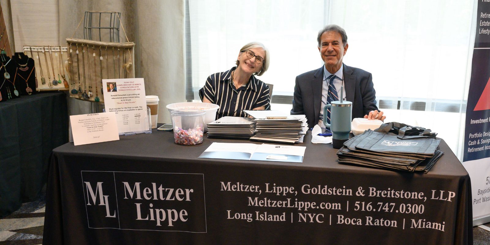 A male attorney and his female marketing director sit at their table.