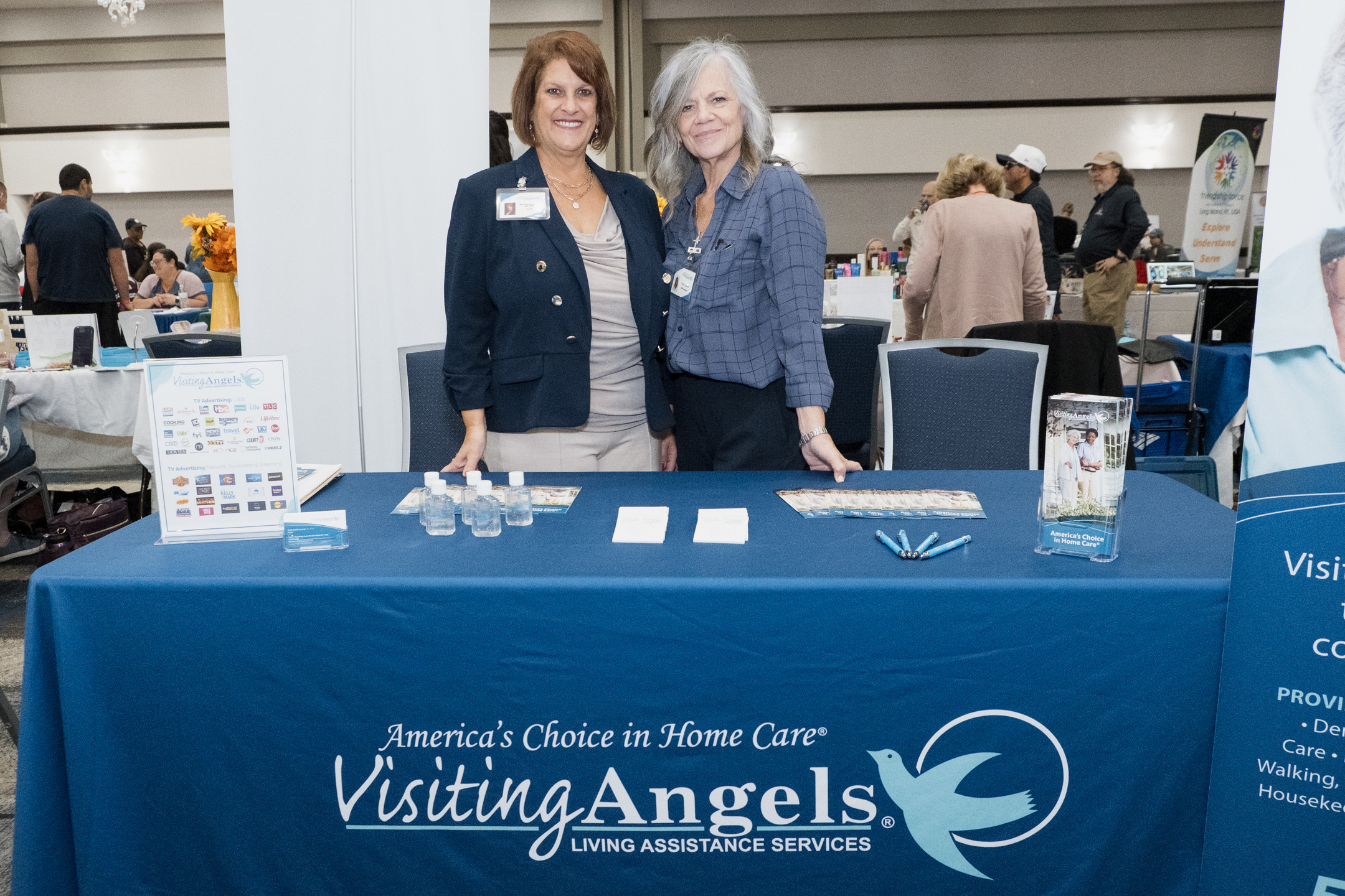 2 representatives from Visiting Angels at their booth