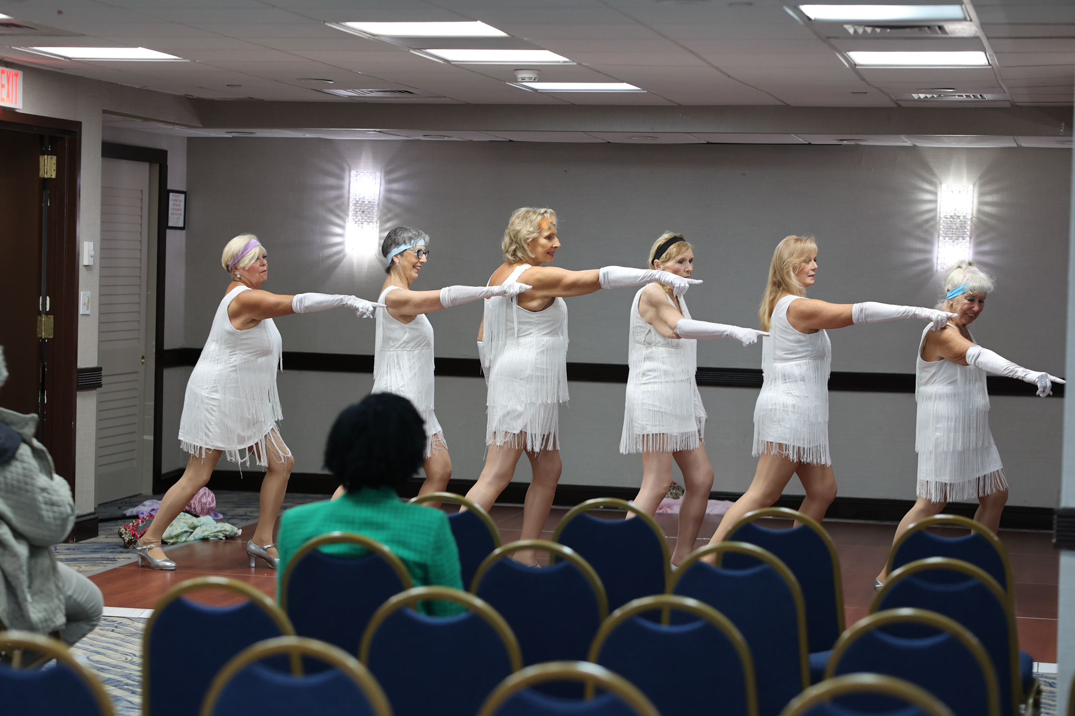Seasoned Steppers dance troupe in white