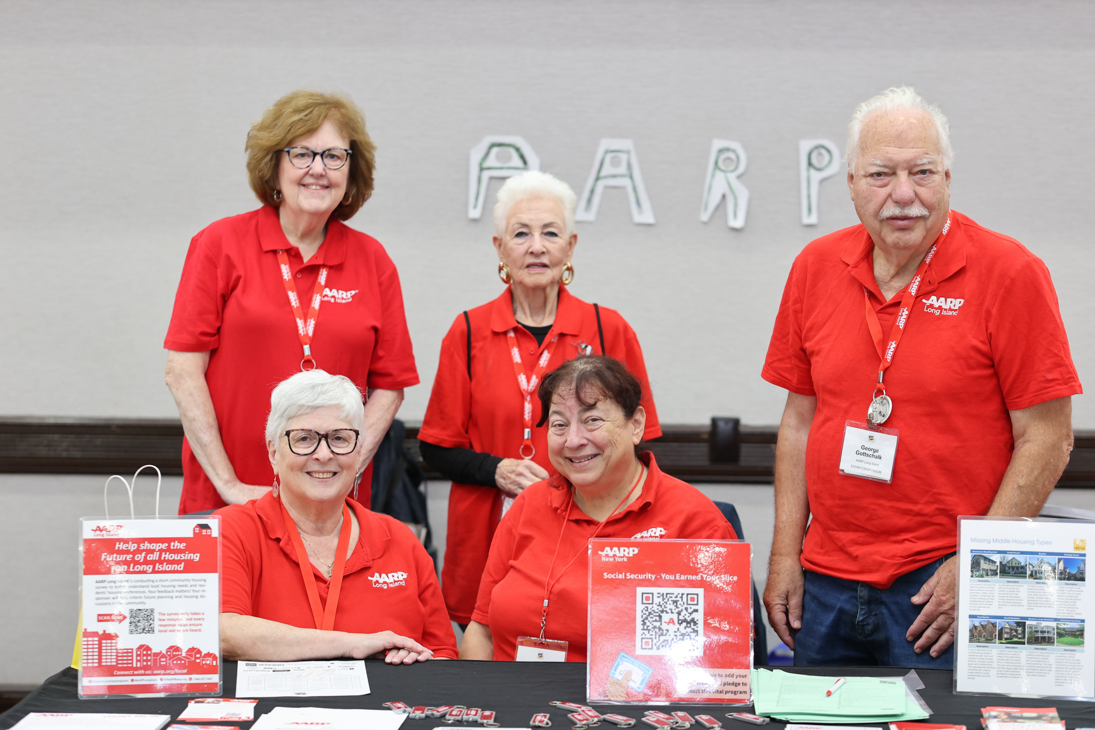 Volunteers from AARP in their signature red shirts